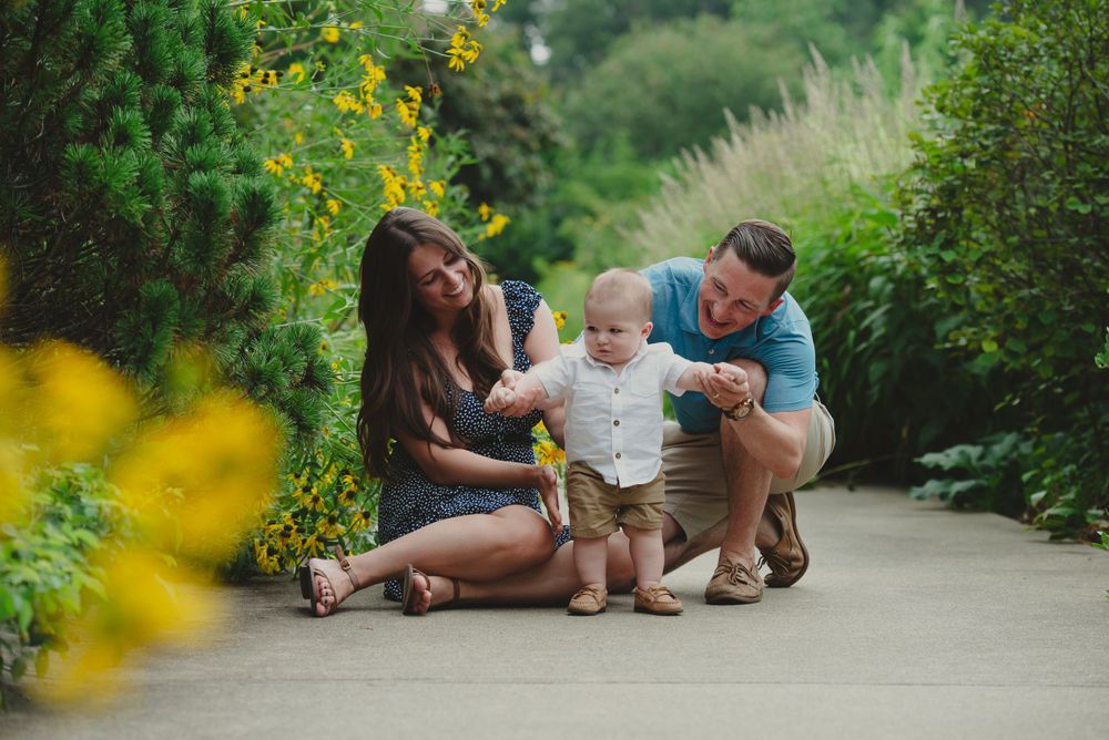 Family with a baby enjoying time together in a garden.